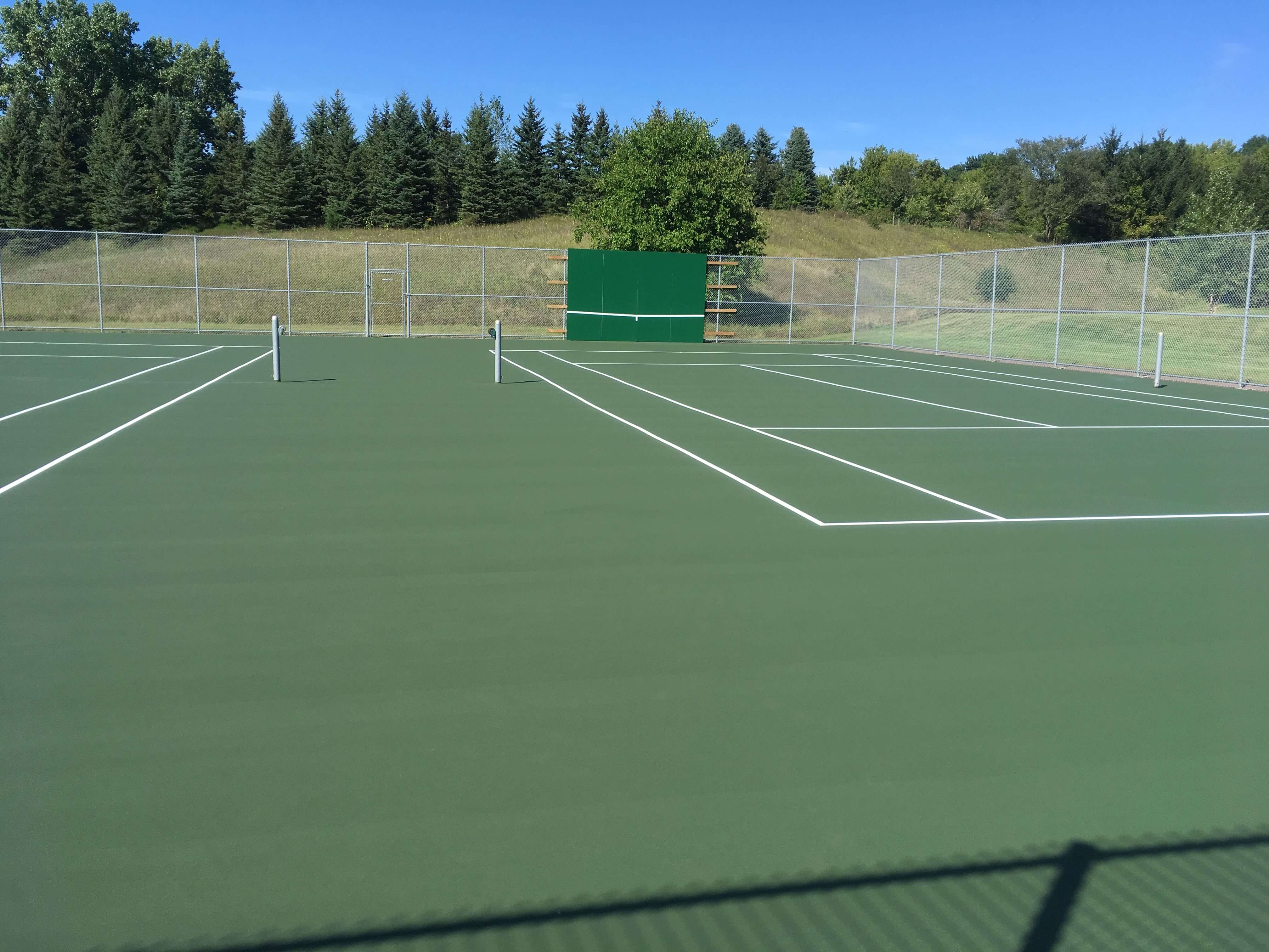 Tennis court after completed resurfacing and crack repair by C & H Sport Surfaces, Inc