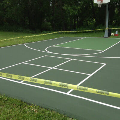 Green basketball court with foursquare lines