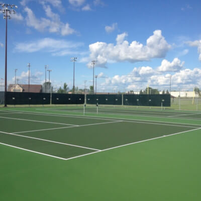 Windscreens attached to fence surrounding Tennis Courts